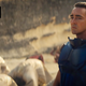 Lee Pace's Emperor/Brother Day/Cleon wears blue armor and stands steel-faced in front of several bowing people in Foundation.